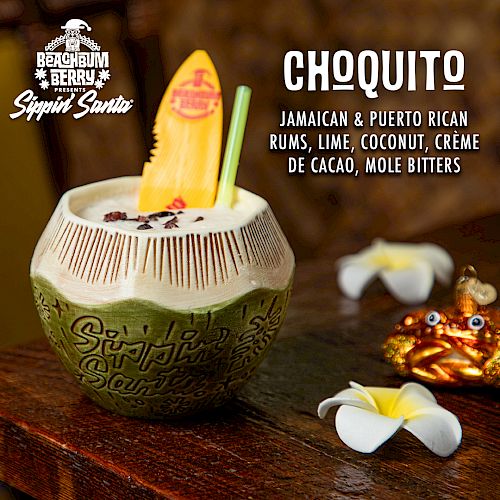 A tropical drink in a decorative cup with ingredients listed: Jamaican & Puerto Rican rums, lime, coconut, crème de cacao, mole bitters.