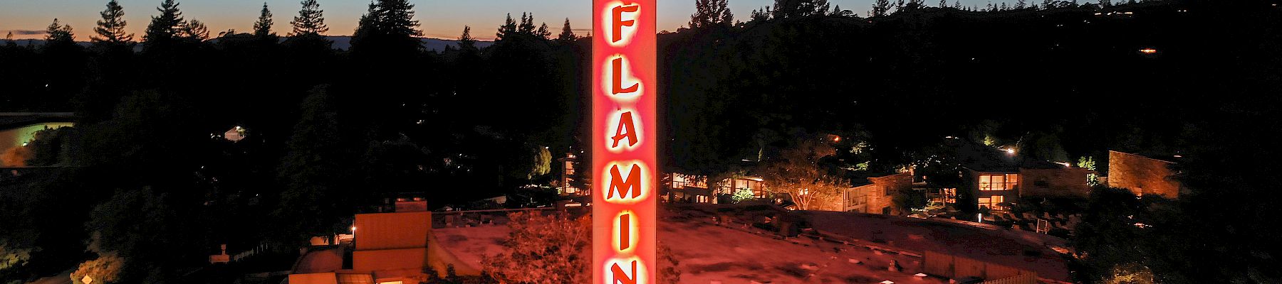 A neon-lit tower with the word 