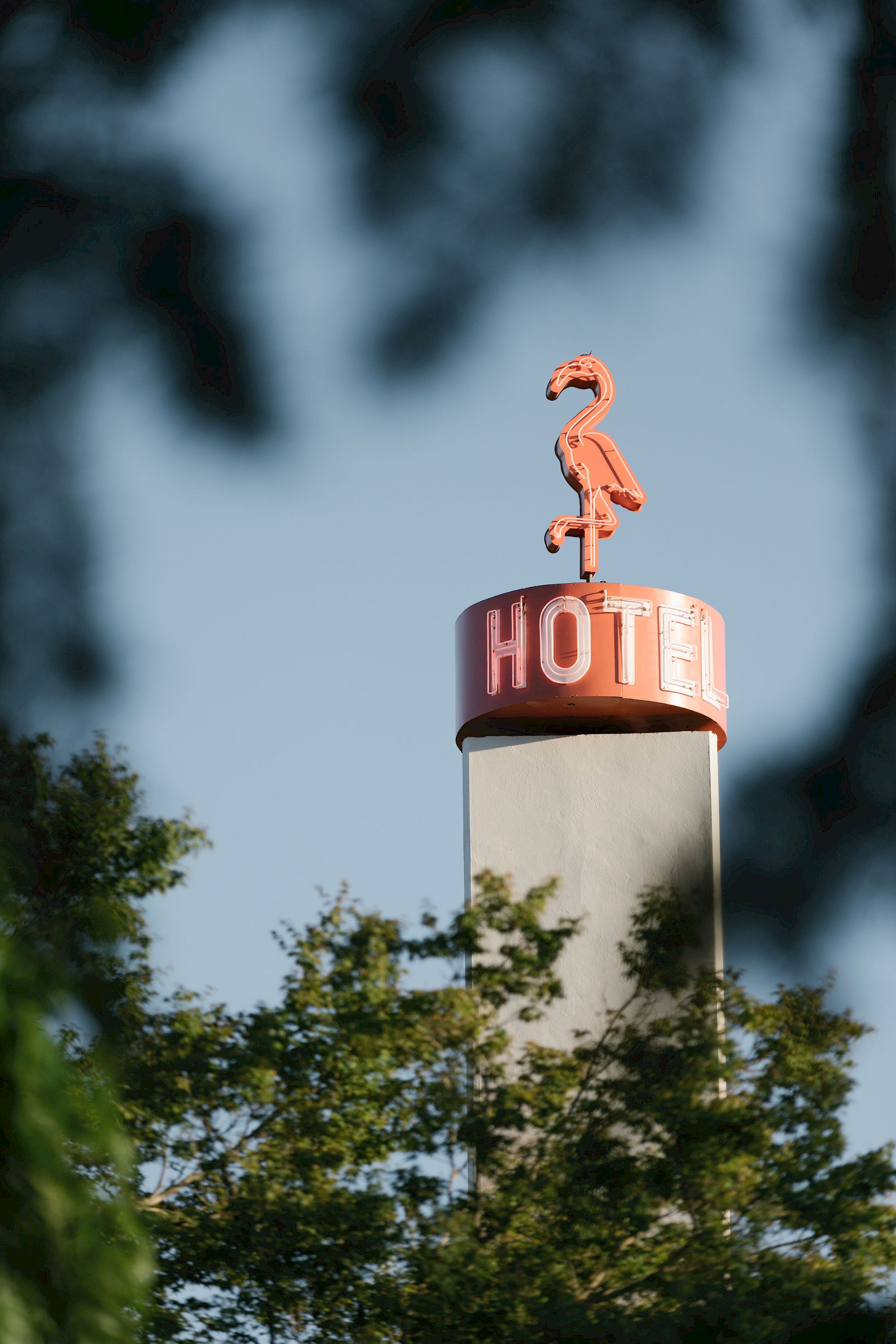 A sign with a flamingo silhouette and the word 