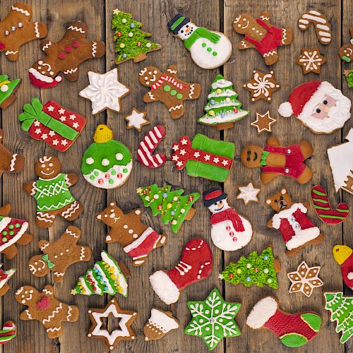 This image features a variety of decorated Christmas cookies, including shapes like trees, snowmen, gingerbread men, Santa, and festive ornaments.