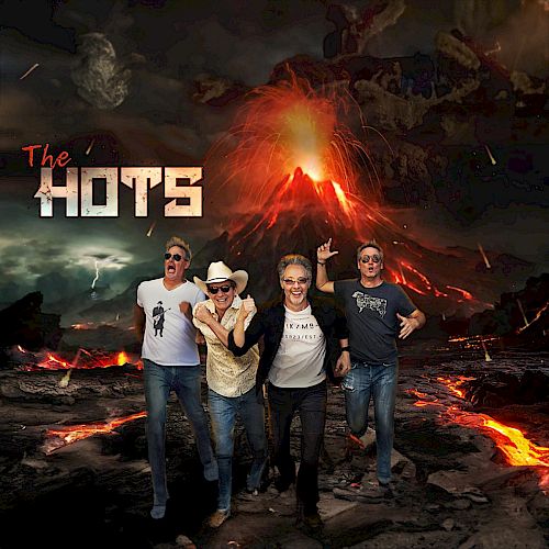 Four people stand in front of a volcanic eruption. The text "The Hots" appears on the left. The background features an erupting volcano and lava.